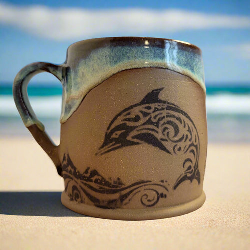 Ceramic mug with a dolphin design on a gradient background