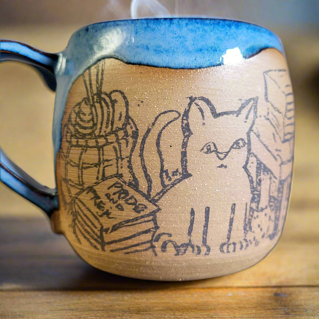 Ceramic mug with cat and books
