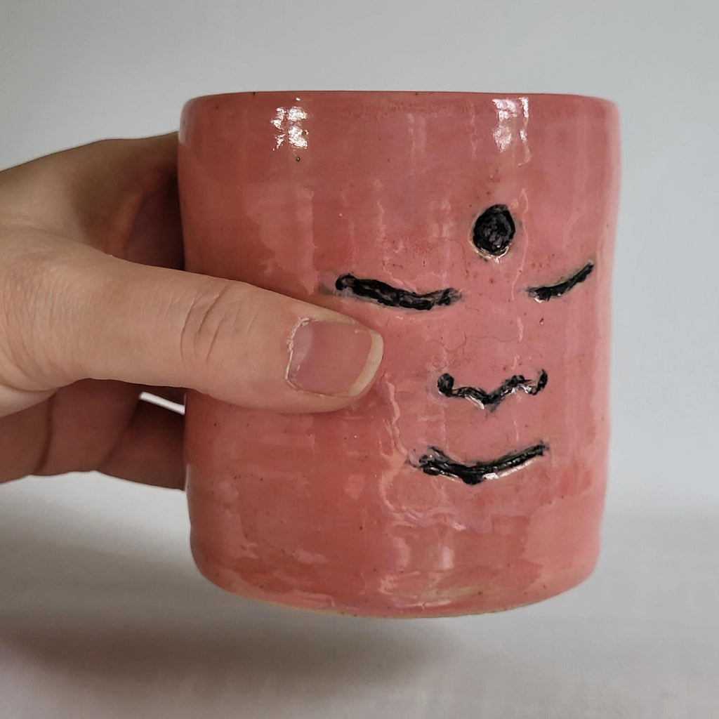 Tea Cup pink, Buddha face, serene happy face carved design. Pink era