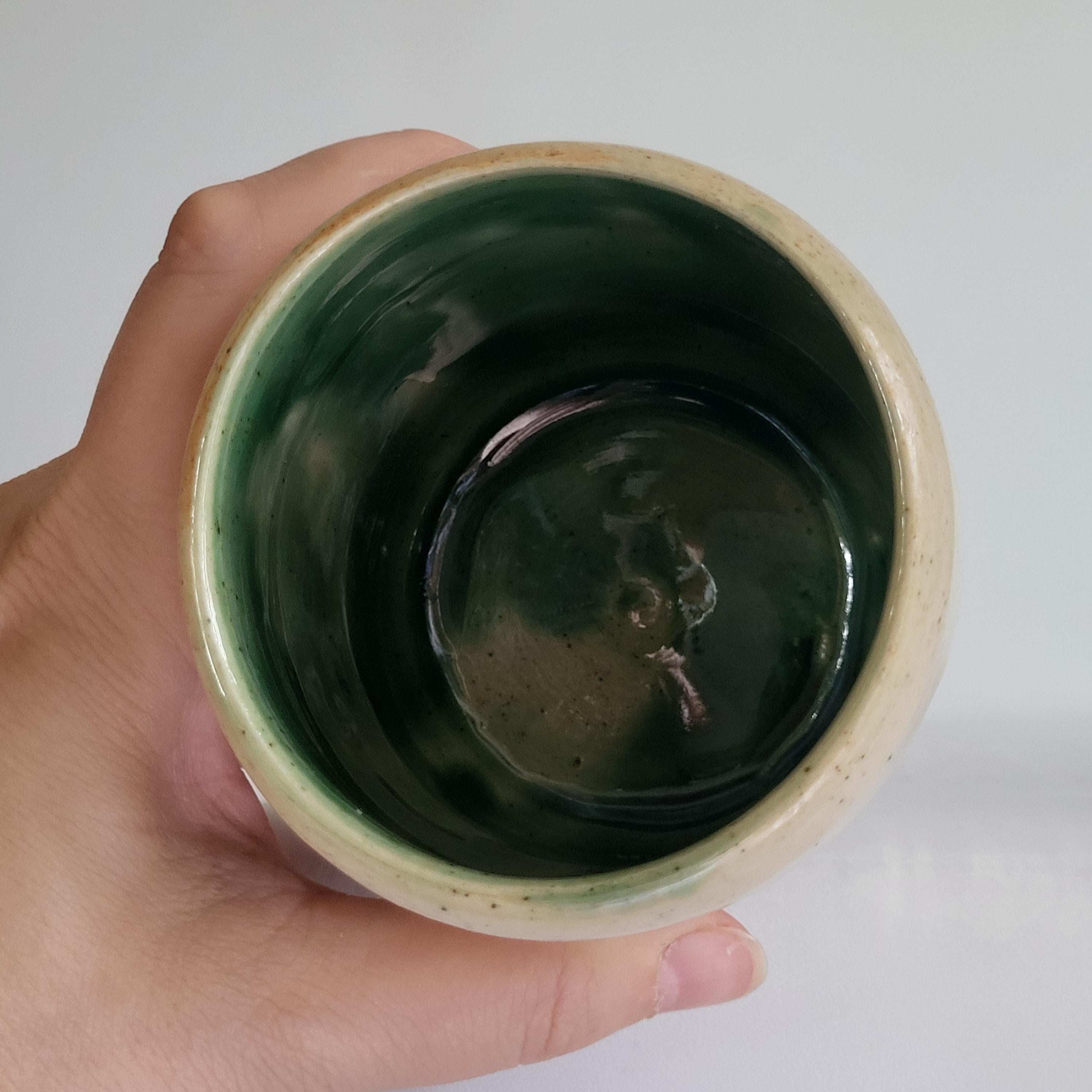 Tea Cup, Buddha face, serene happy face carved design.