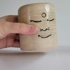 Tea Cup, Buddha face, serene happy face carved design.